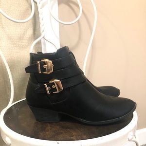 Black booties with gold buckle
